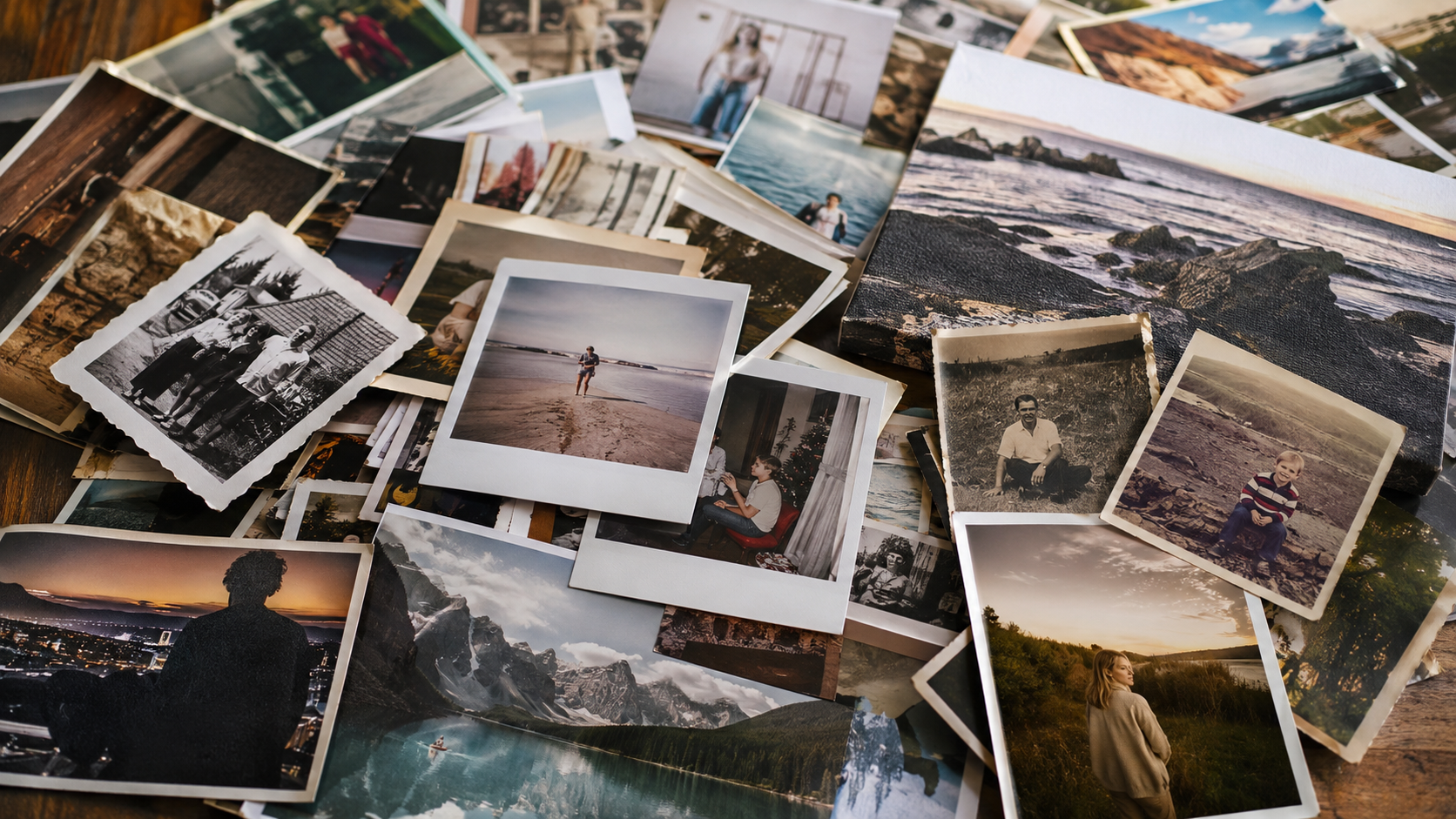 pile of photos, old and new, polaroid and prints scattered all over